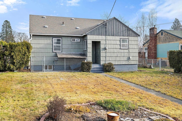 rear view of property featuring a yard