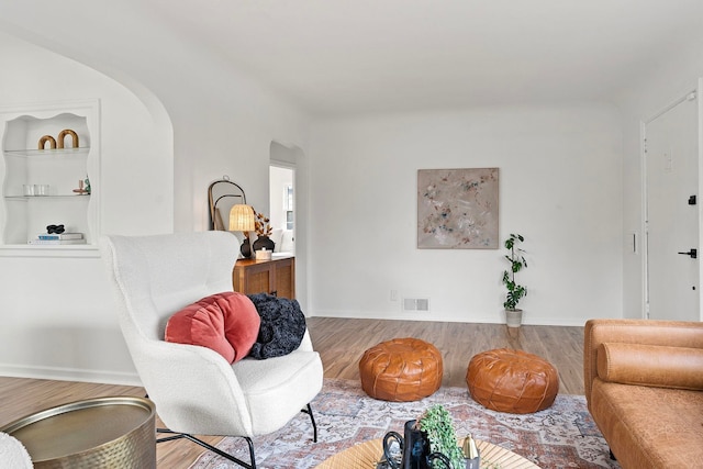 living area featuring light hardwood / wood-style floors and built in features