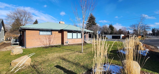 view of property exterior with a lawn