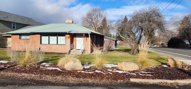 view of side of property with a lawn