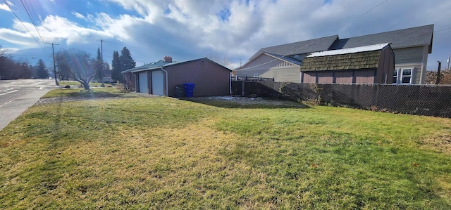 view of yard with a garage and an outdoor structure