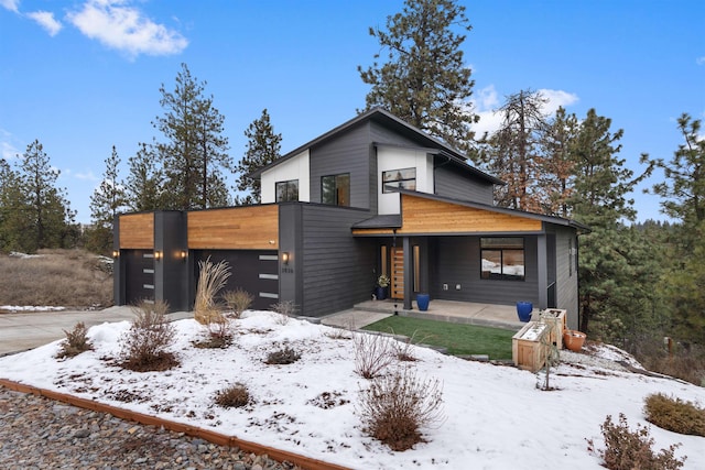 contemporary house featuring a garage and a porch