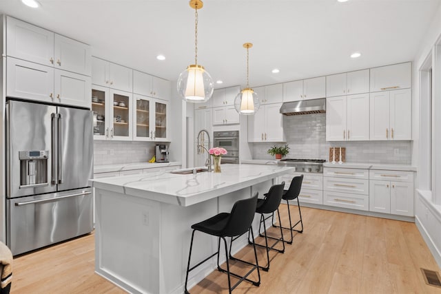 kitchen featuring stainless steel appliances and white cabinetry