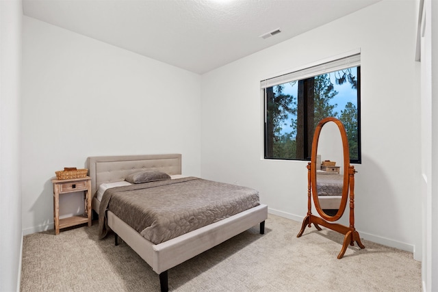 bedroom with light colored carpet