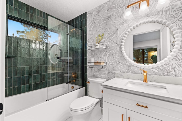 full bathroom featuring toilet, enclosed tub / shower combo, vanity, tile walls, and a textured ceiling