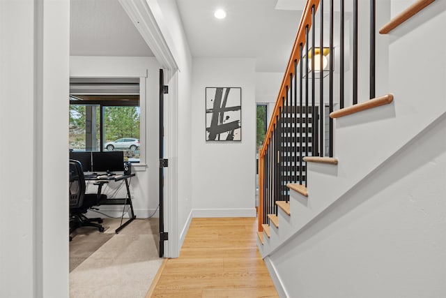 staircase featuring wood-type flooring