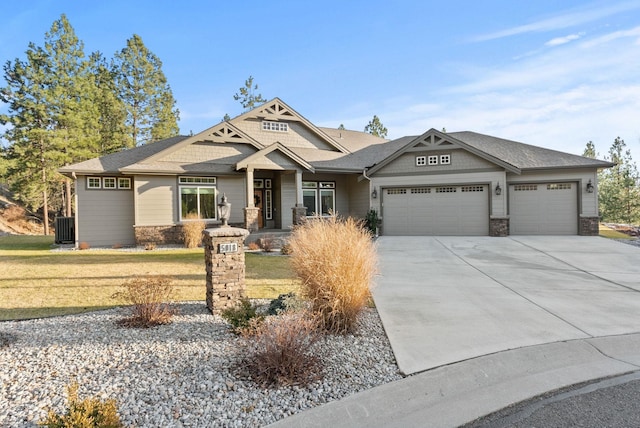 craftsman-style home with central AC unit, a front lawn, and a garage