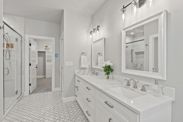 bathroom with a shower with shower door and vanity