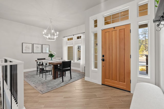 dining space featuring an inviting chandelier and a healthy amount of sunlight