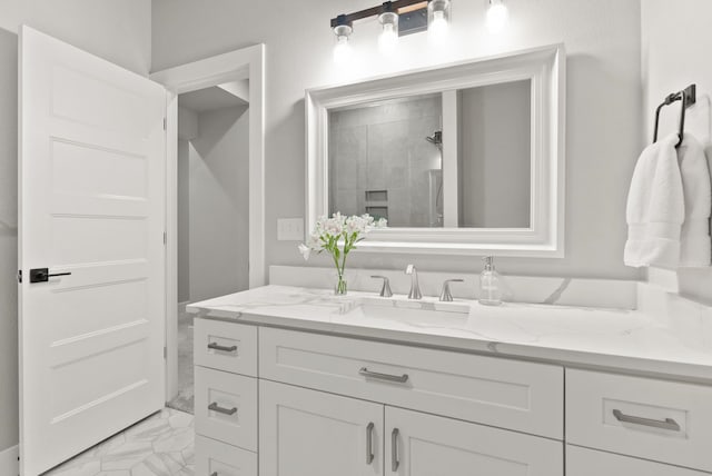 bathroom featuring walk in shower and vanity