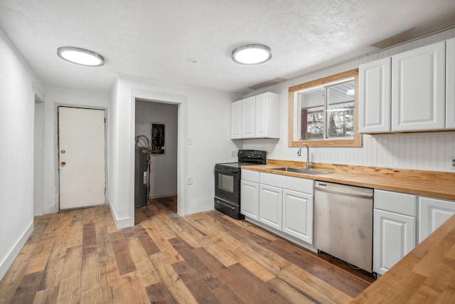 kitchen with dishwasher, butcher block countertops, black range with electric cooktop, white cabinets, and sink