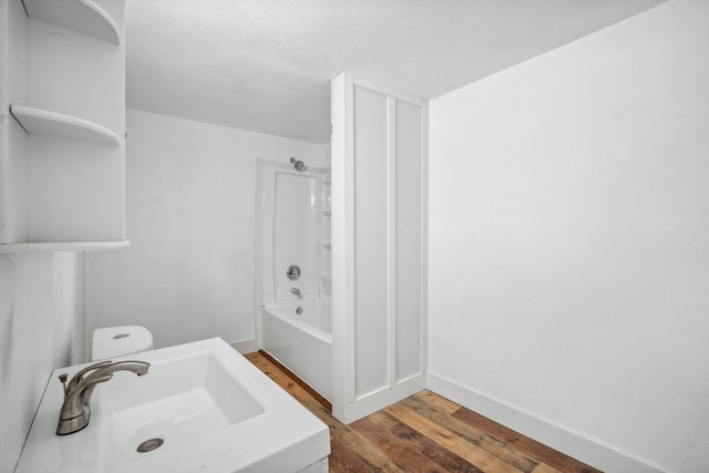 full bathroom with sink, wood-type flooring, toilet, and bathing tub / shower combination