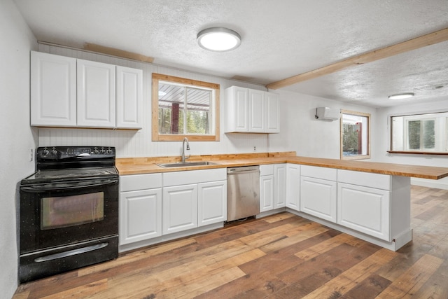 kitchen featuring kitchen peninsula, stainless steel dishwasher, electric range, white cabinetry, and sink