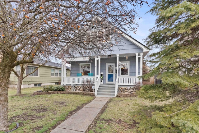 bungalow-style home with a front yard and a porch