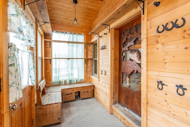 mudroom with vaulted ceiling, carpet, wood ceiling, and wood walls