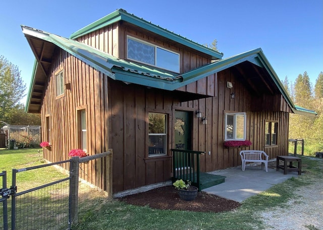 back of property featuring a patio area and a yard