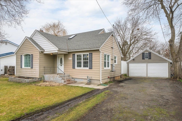 bungalow-style home with an outbuilding, a front yard, and a garage