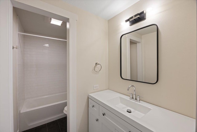 full bathroom with tile patterned floors, toilet, vanity, and tiled shower / bath combo