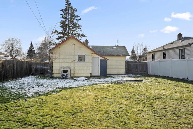 rear view of property with a lawn