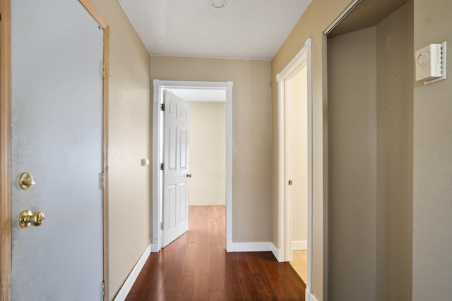 corridor featuring dark hardwood / wood-style floors