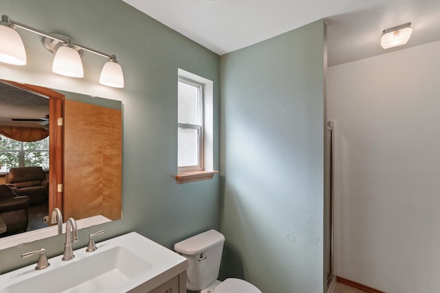 bathroom featuring toilet and vanity