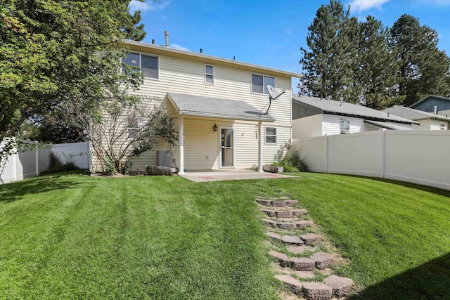 back of house with a lawn and a patio area