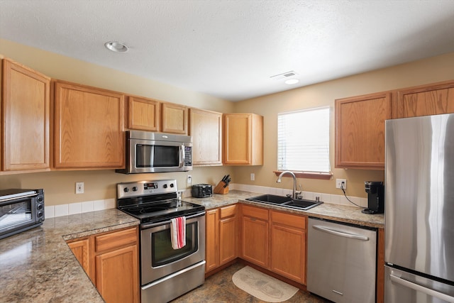 kitchen with sink and appliances with stainless steel finishes