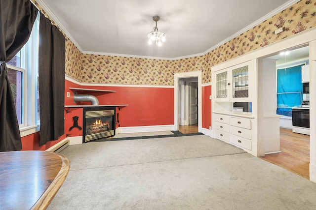 carpeted living room with baseboard heating, ornamental molding, and a notable chandelier