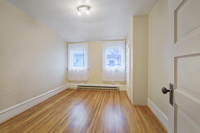 interior space with a baseboard radiator and light hardwood / wood-style flooring