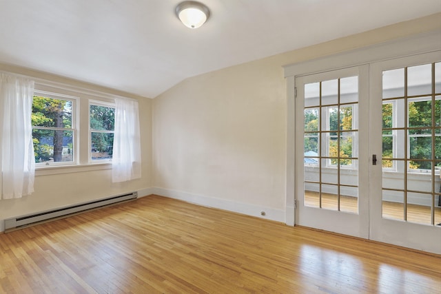 unfurnished room with vaulted ceiling, baseboard heating, french doors, and light wood-type flooring