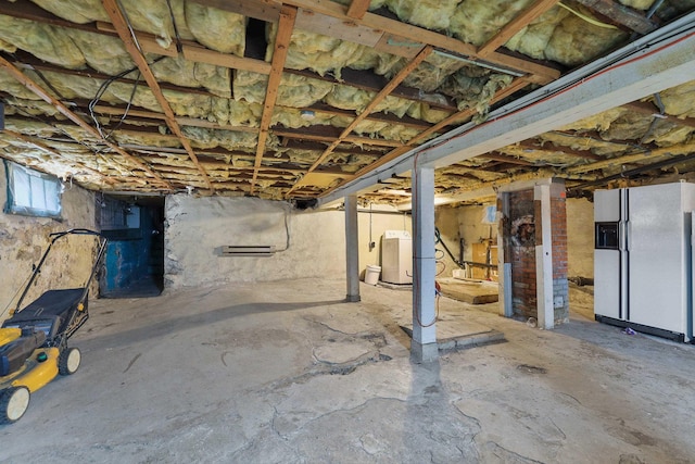 basement featuring white refrigerator with ice dispenser and washer / clothes dryer