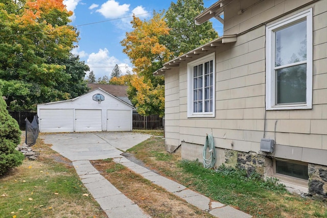 view of property exterior with a garage, an outbuilding, and a yard