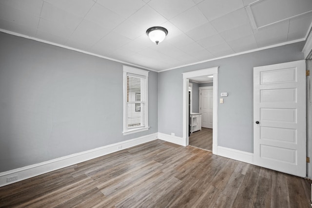 unfurnished bedroom featuring ornamental molding and hardwood / wood-style floors