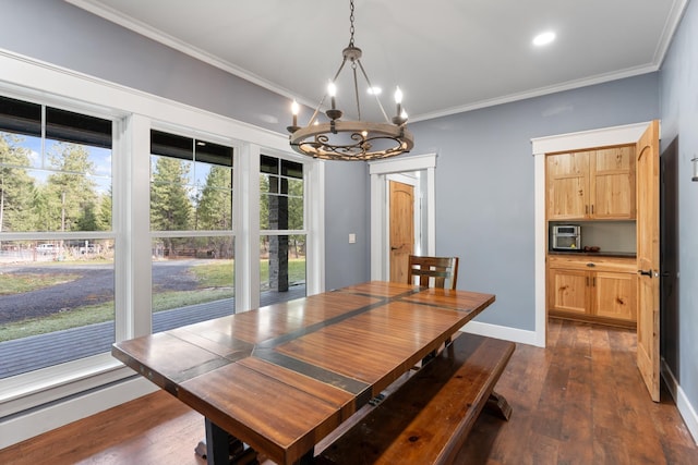 dining area featuring dark hardwood / wood-style floors, ornamental molding, and an inviting chandelier