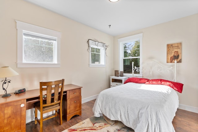 bedroom with dark hardwood / wood-style floors