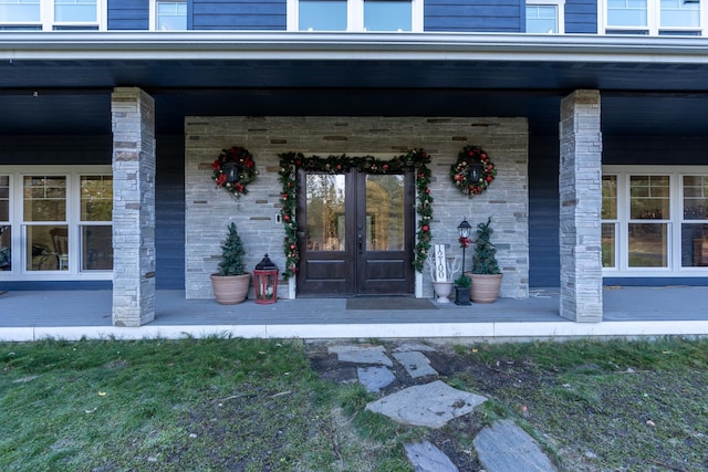 property entrance featuring french doors and covered porch