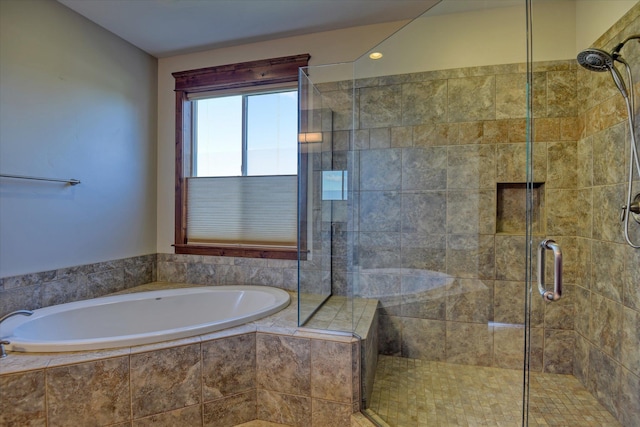 bathroom featuring independent shower and bath