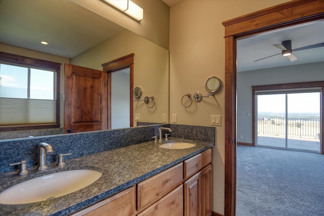 bathroom with ceiling fan and vanity