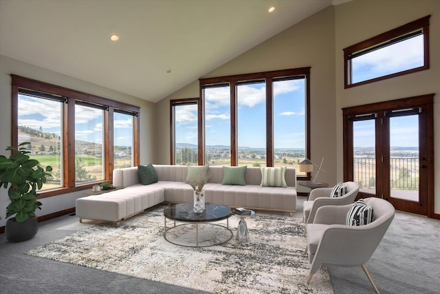 sunroom / solarium with a healthy amount of sunlight and vaulted ceiling