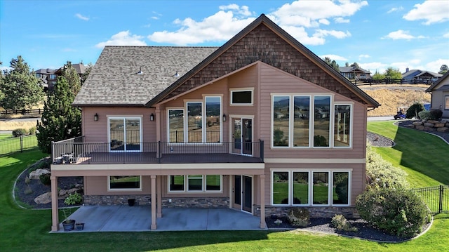 rear view of property with a patio area, a yard, and a balcony