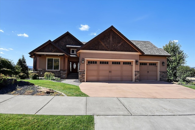 craftsman house with a garage and a front lawn