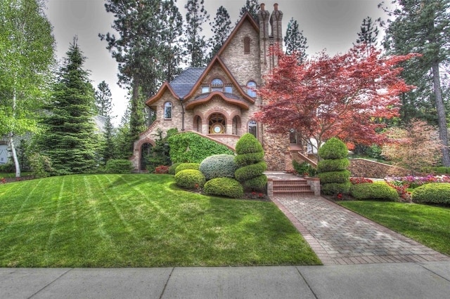 tudor-style house with a front yard