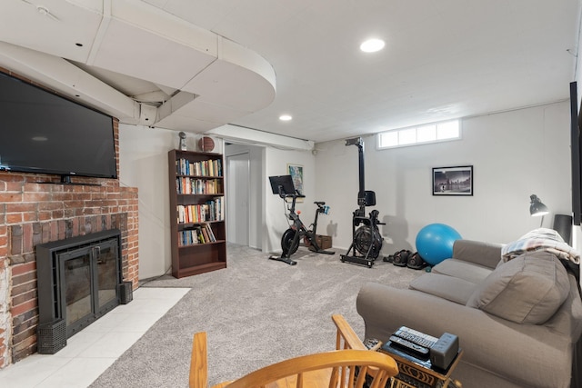 exercise room featuring light colored carpet and a fireplace