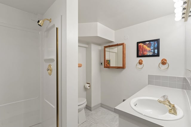 bathroom with toilet, a shower, tile patterned flooring, and vanity