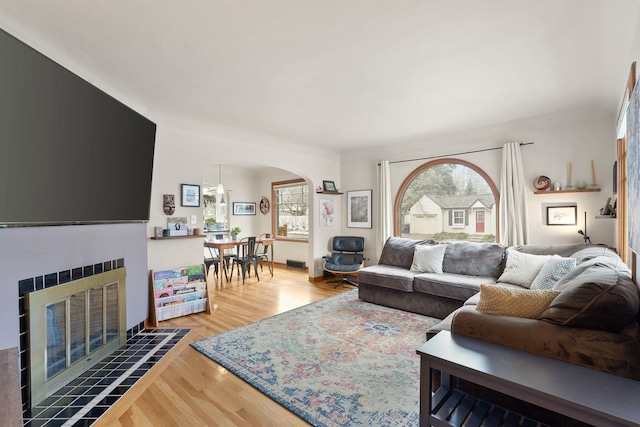 living room with a fireplace and hardwood / wood-style floors