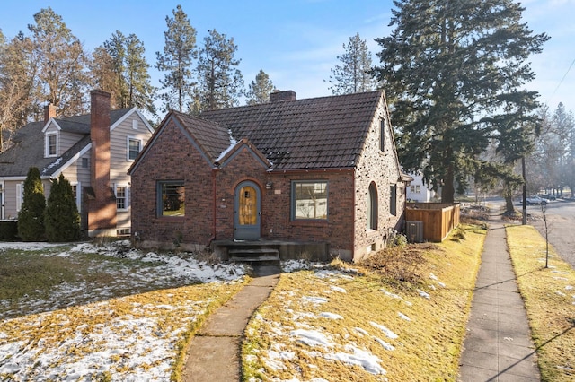 tudor-style house featuring central AC unit