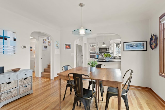 dining space with light hardwood / wood-style floors