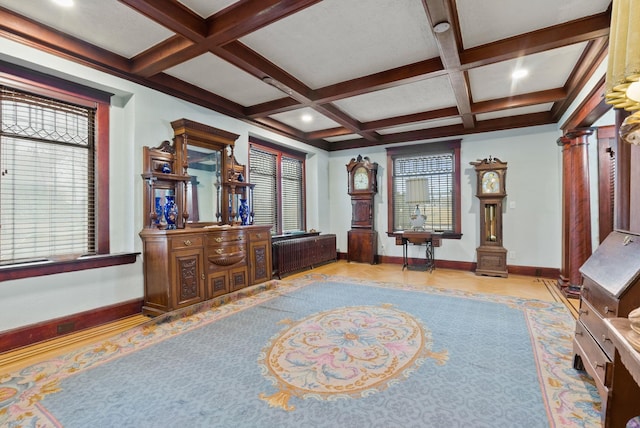 interior space featuring ornate columns, baseboards, and coffered ceiling