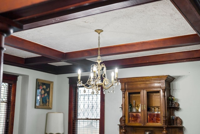 room details with beam ceiling and a notable chandelier