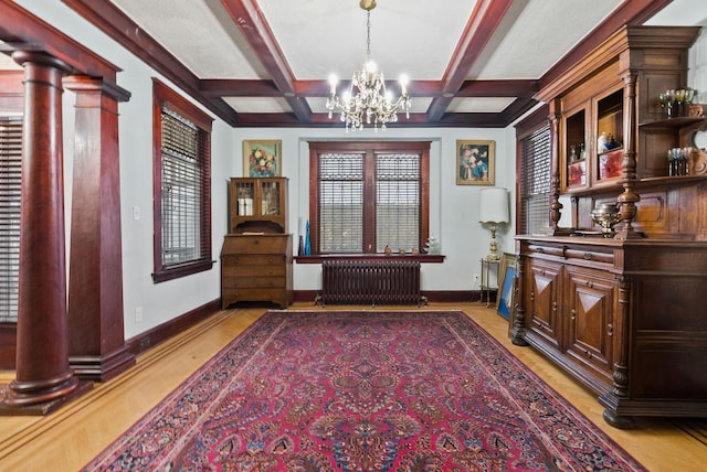 interior space featuring radiator heating unit, a notable chandelier, baseboards, and coffered ceiling